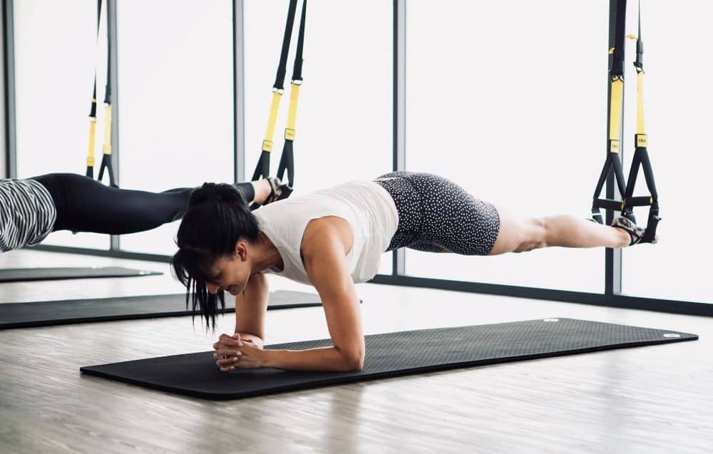 TRX Planks involves placing your feet in each of the foot cradles while performing a plank